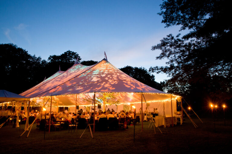 Wedding tent at night - Special event tent lit up from the inside with dark blue night time sky and trees